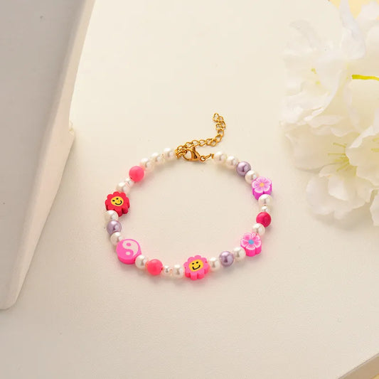 Pulsera multicolor con flores y perlas
