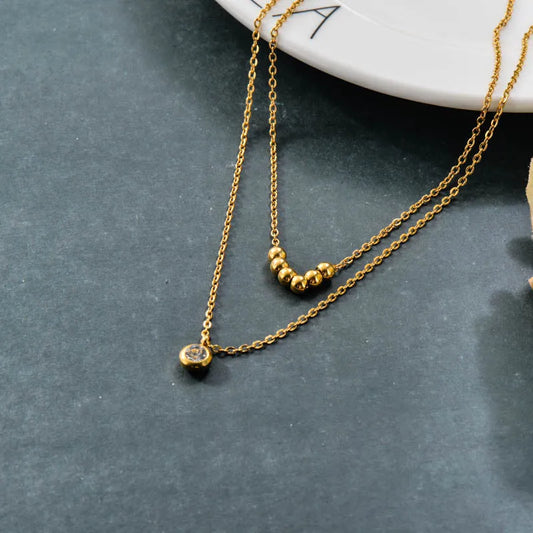Collar Doble Dorado con Dije y Esferas